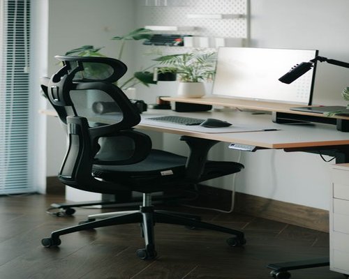 Ergonomic desk setup showing proper distance between chair and computer monitor